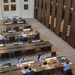 overhead shot looking down at students studying in the law school reading room.