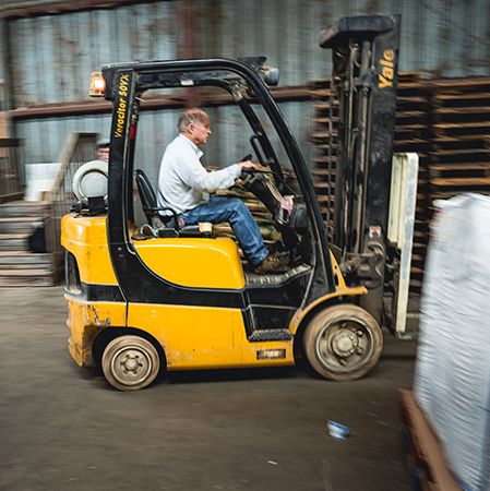 Man operating forklift in warehouse