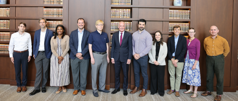 New faculty posing in the beautiful reading room