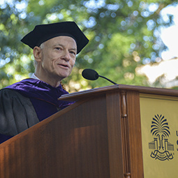 Dean Hubbard speaking at the podium during commencement
