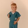 Gabbie Rhinehart wearing scrubs as a child.