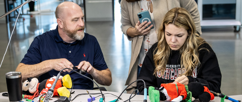 Instructor and student at adapted toy workshop