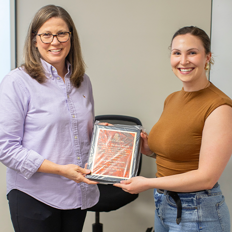 Wilczynski accepting the Dean C. Barnhart Award from Biomedical Science Graduate Director Edie Goldsmith