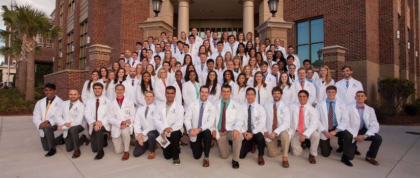 Students posing in white coats. 