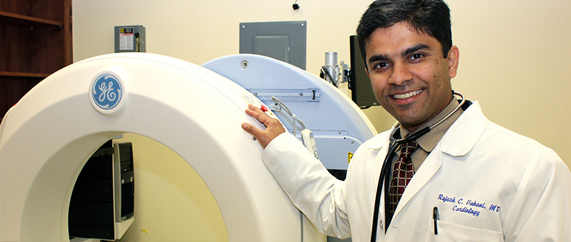 Doctor standing next to an MRI