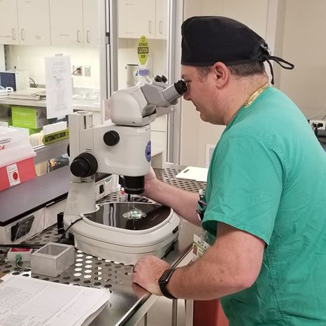 Richard Kordus working on a microscope in the lab