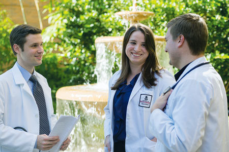 Medical students standing by a fountain
