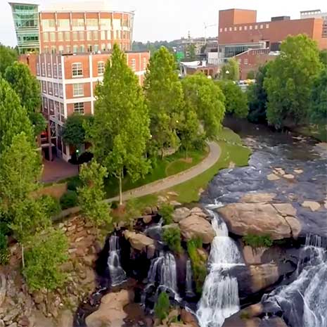 Aerial view of the river, falls and buildings in Greenville, SC.