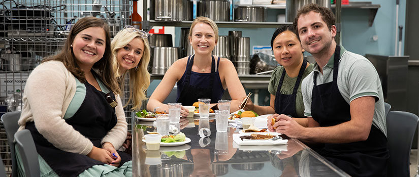 Students Smiling and Cooking