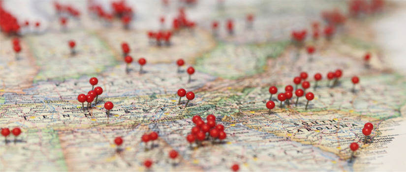 A map with red push pins showing different locations.