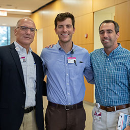 Three people smiling