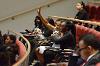 A student attending the conference raising her hand to ask a question