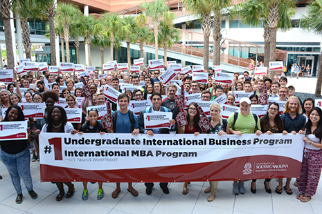 Group of students in the Darla Moore School of Business courtyard celebrating the No. 1 U.S. News & World Report ranking for the 21st consecutive year