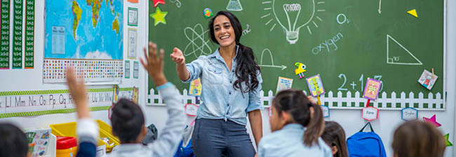 Stock image of a teacher in a children's classroom