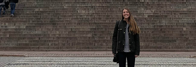 Image of Halle Hughes in front of the Helsinki Cathedral in Finland