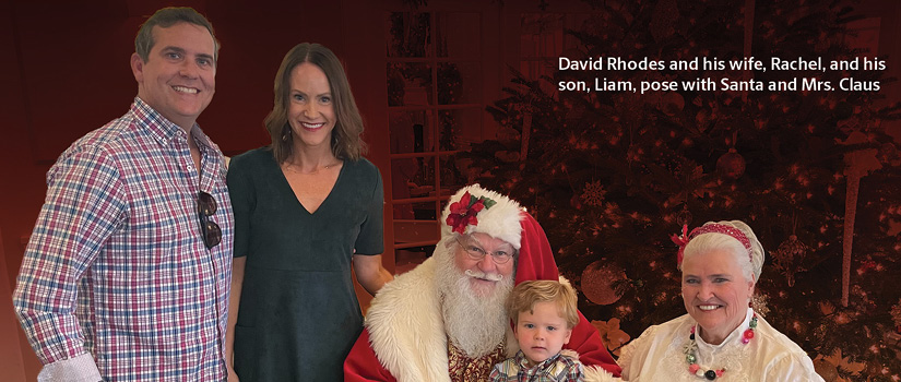 Image of David Rhodes and his family with Santa and Mrs. Claus