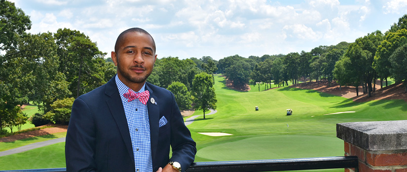 Image of Dominique Gray in front of a golf course