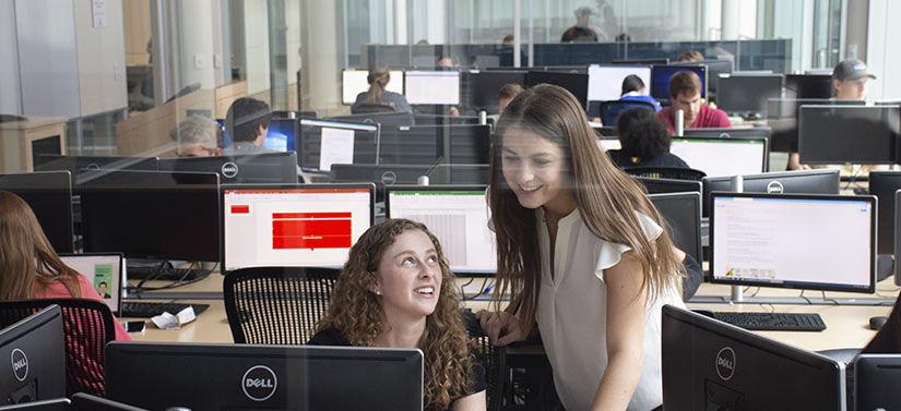 Two female students working in the trade room