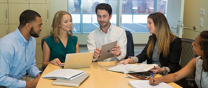 MHR students working on a project in a Moore School conference room