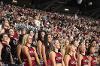 Excited Coquettes and Carolina Rhythm members watch a football game from the stands