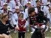 Drum major and twirler show a young Carolina fan a baton