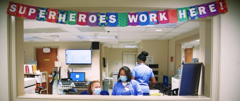 photo of nurses station with banner heroes work here