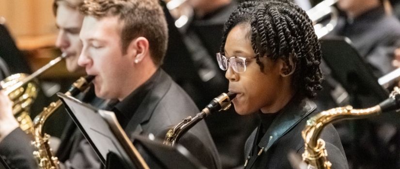 African American woman playing saxophone in the Wind Ensemble