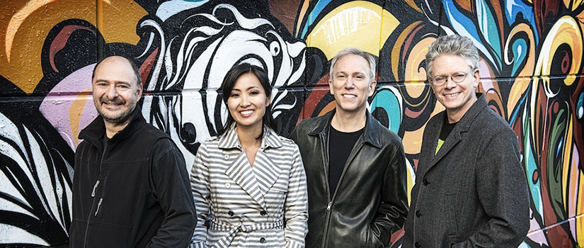 Kronos Quartet standing in front of graffiti wall