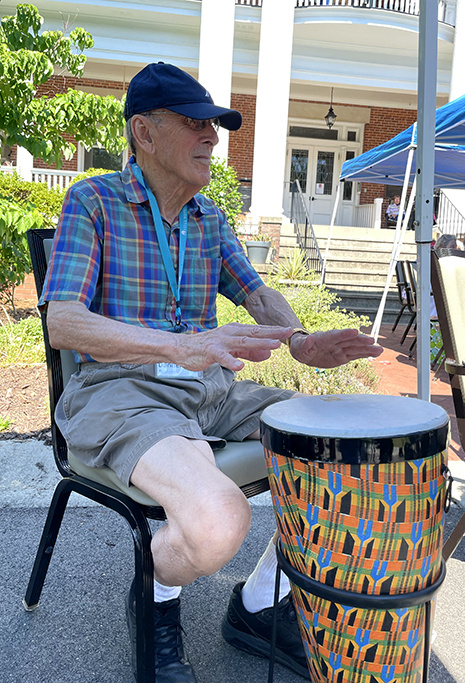 Resident learns to "rumble" in a drum circle.