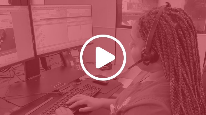 Woman at a computer wearing headset