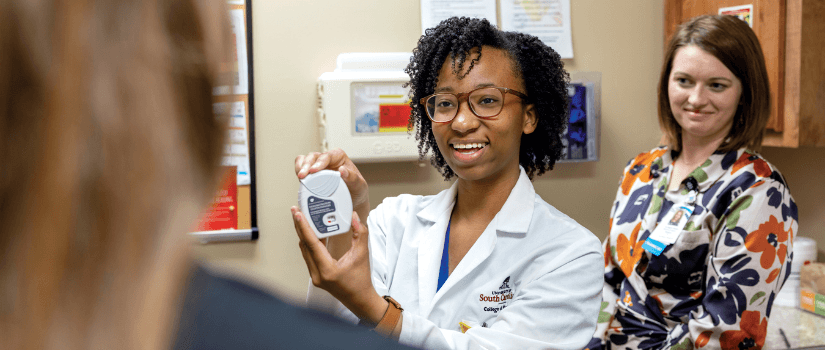 Pharmacy student demonstrating medical device