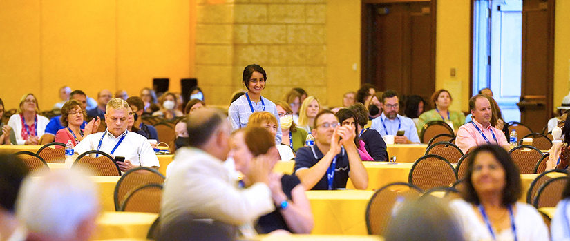 Pharmacy student standing for applause in banquet room