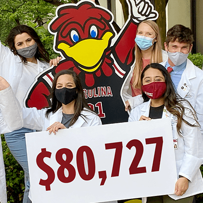 Students holding sign