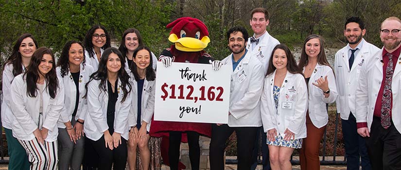 Group of students holding sign