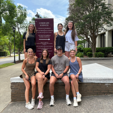 Group of students with sign outside college of pharmacy