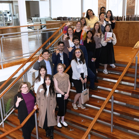 Graduate students pose on stairs for a photo