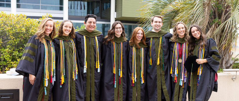 Group of graduates in robes smiling