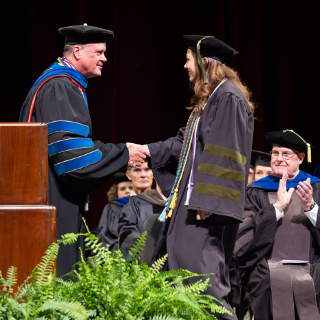 Dean shaking hands with graduate