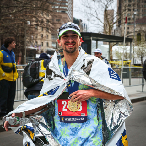 Runner in silver blanket smiling for photo