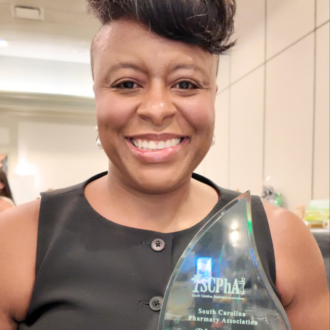 Woman holding award