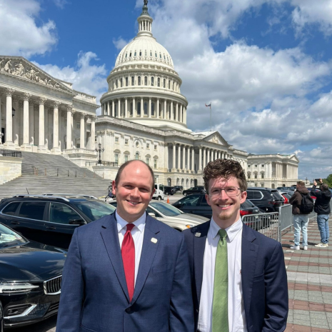 Two students in front of capitol building