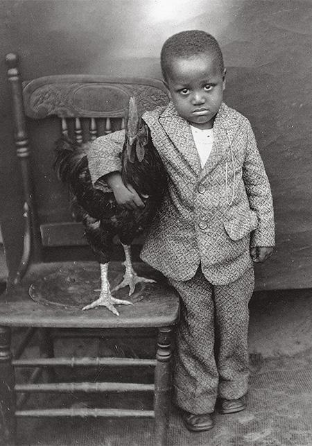 boy with his pet rooster