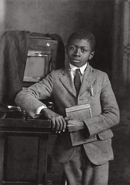 Cornelius C. Roberts standing with his father's camera