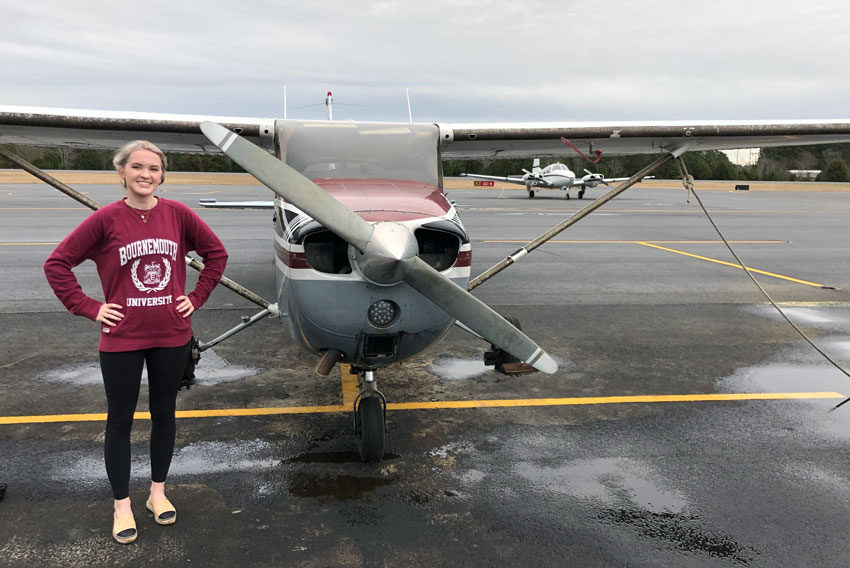 Jaden Sorbie stands beside a small airplane.