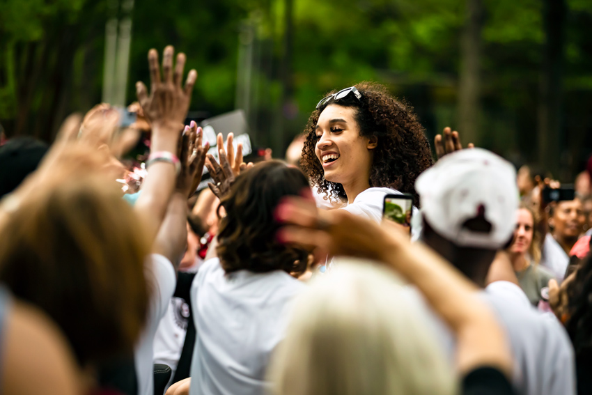 Brea Beal waves to the crowd from a convertible during the 2022 championship parade. 