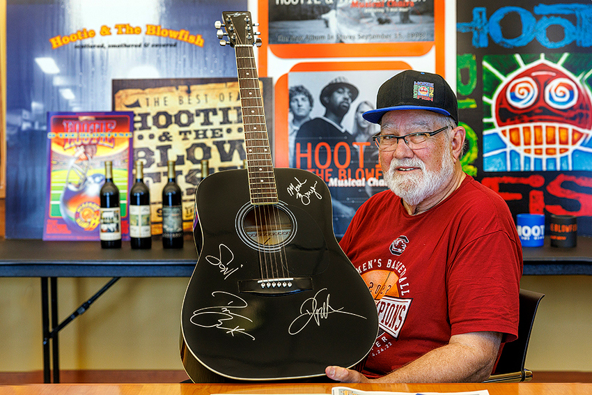 Hootie collector Rick Noble with some of the memorabilia he donated to University Libraries, including a guitar signed by the four band members.