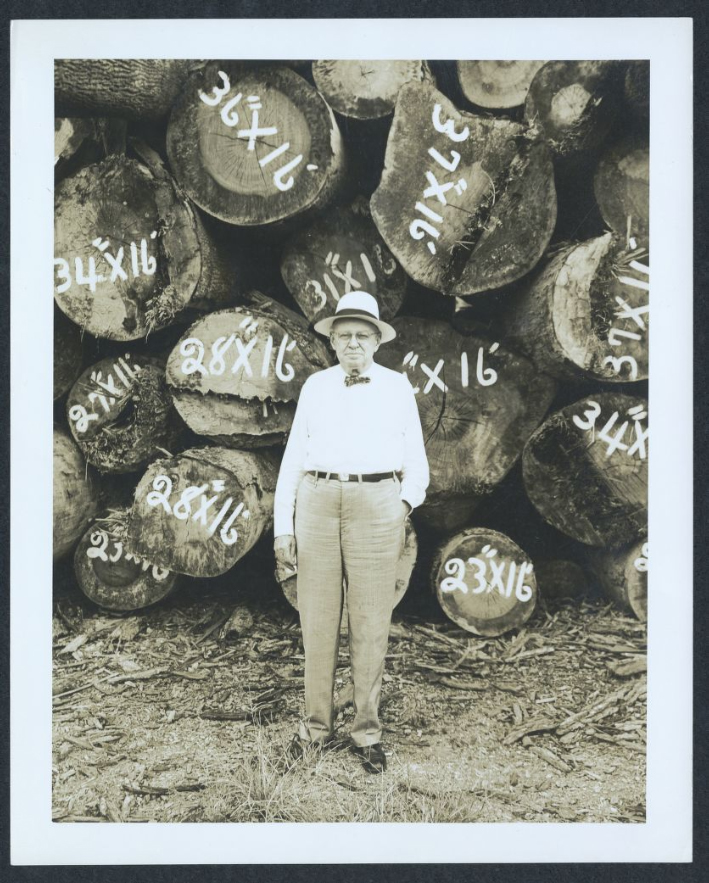 Oliver Lafayette Williams (1865-1952), the "Williams" in Williams-Brice Stadium, poses in front of log inventory.