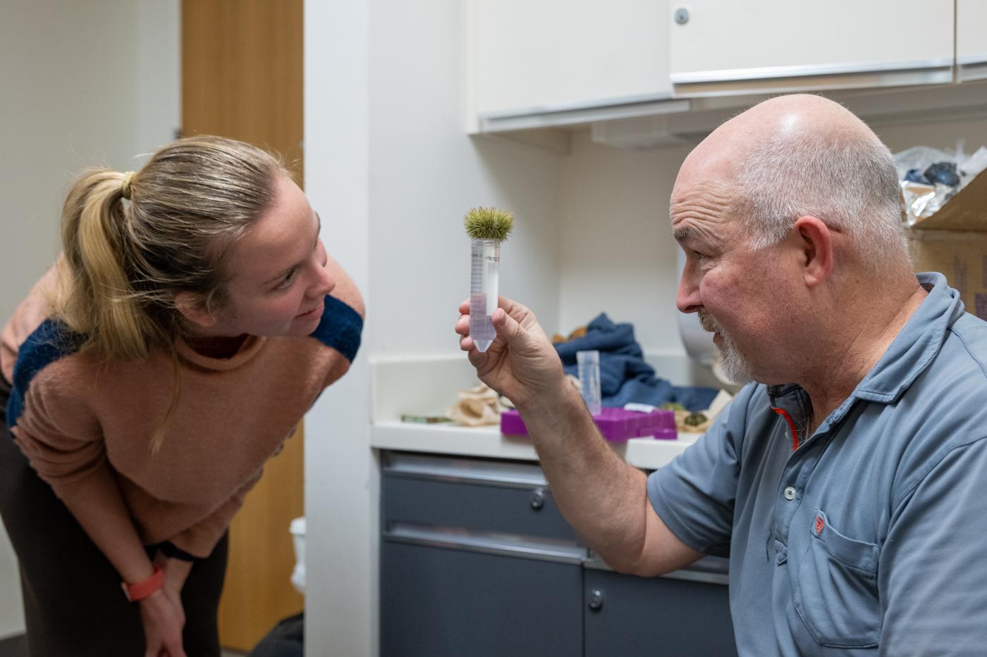Professor Roudebush observes a gravid sea urchin releasing gametes.