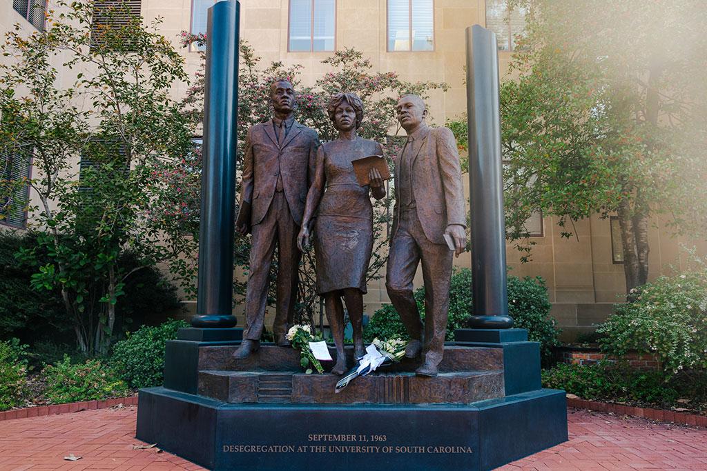 A photo of flowers at the base of the desegregation monument.