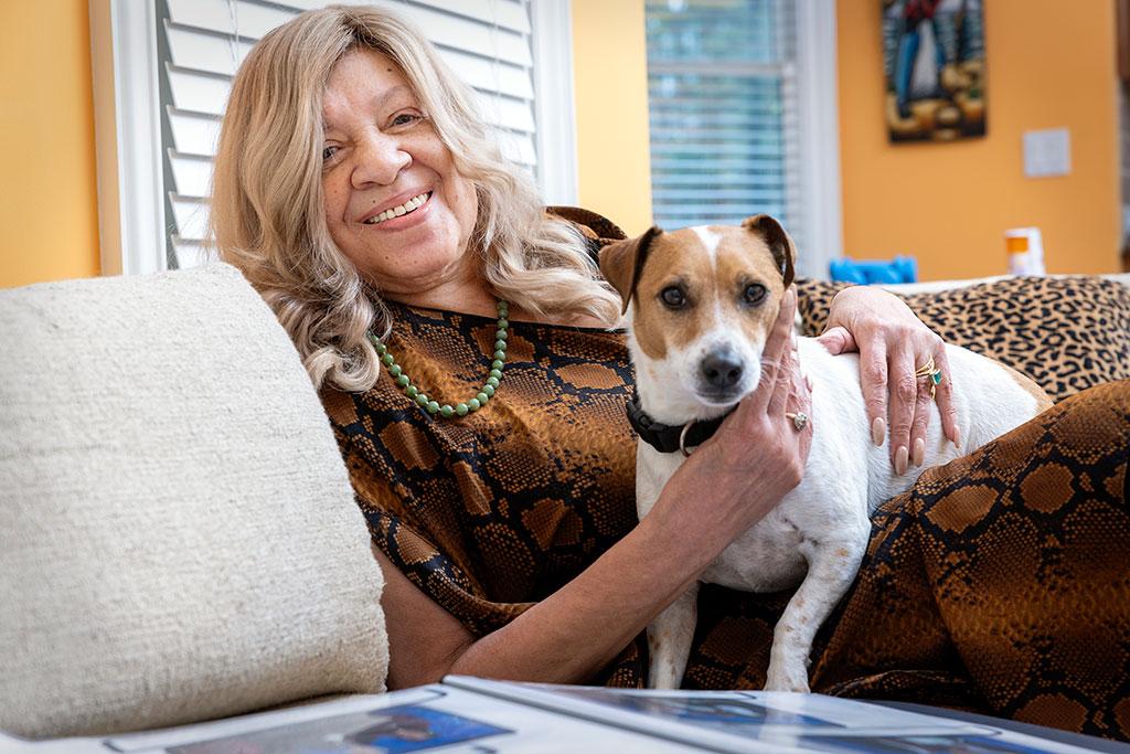 Treadwell holds her Jack Russell terrier on her sofa.